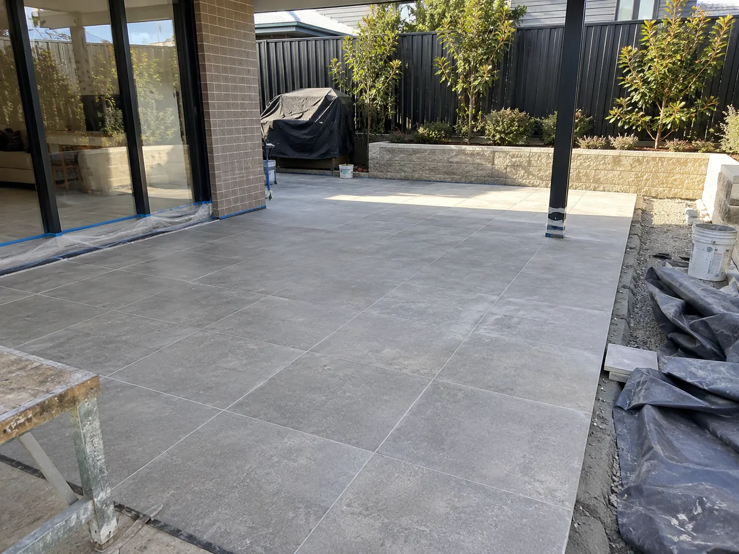 Large-format tiles across a covered alfresco area