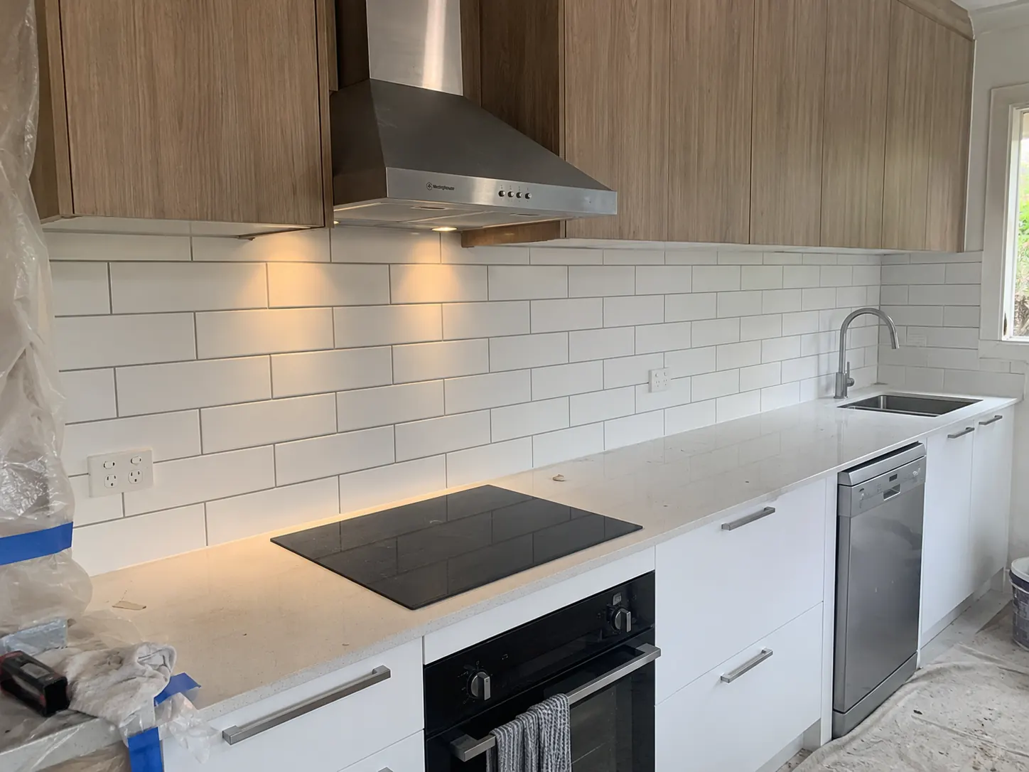 White subway tiles above a kitchen benchtop