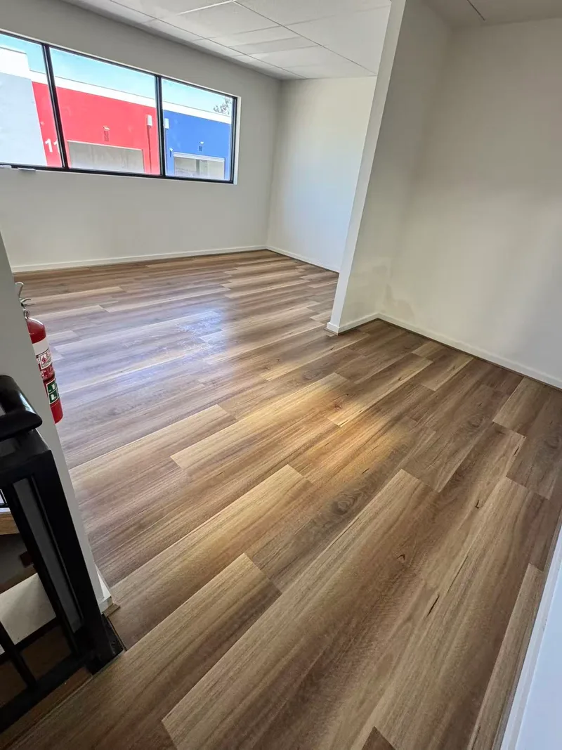 Completed timber floor with a window and adjoining wall