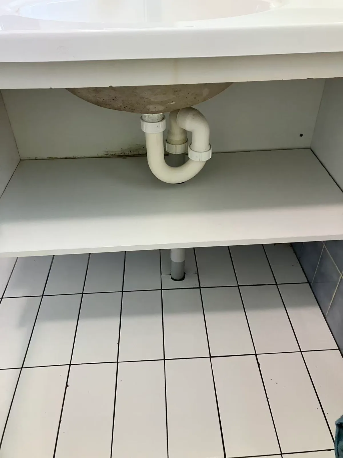 Recorded after view of vanity pipework and adjoining floor tiles at King William Street
