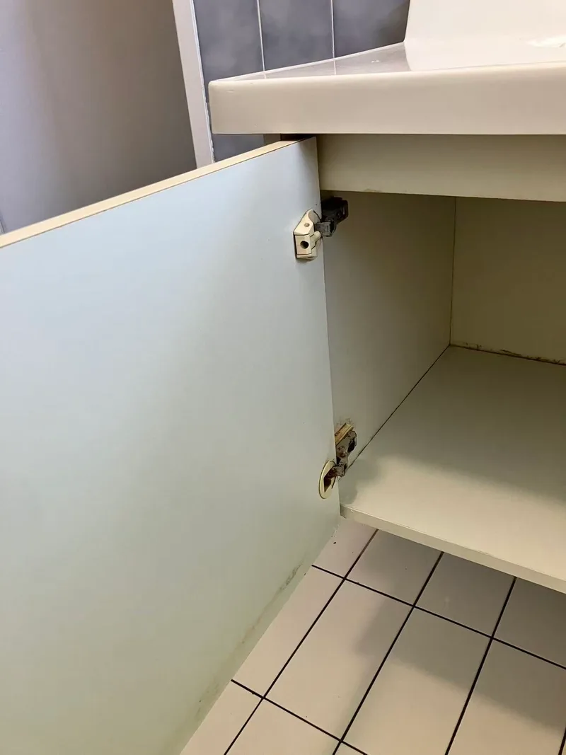 Vanity door open beside the tiled floor during the project